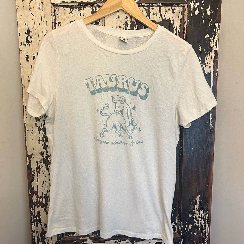 Women’s Life Elsewhere Taurus zodiac T-shirt.  Courageous Adventurous Ambitious